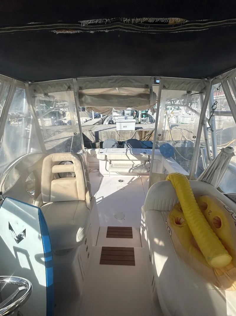 Slide: The Image of 2005 Grady-White Marlin 300 boat interior with seating and clear canopy. - 9