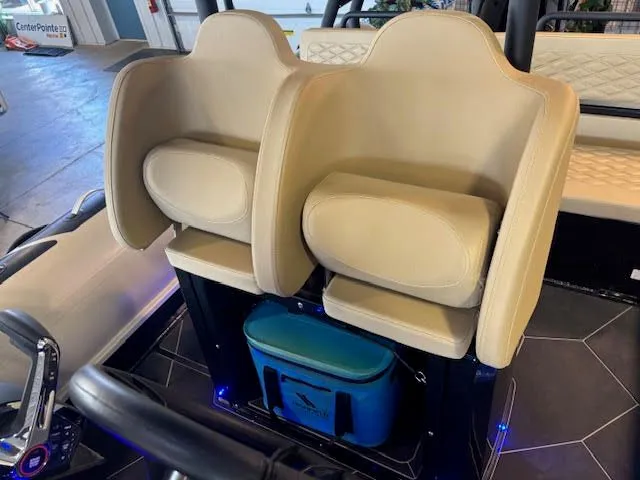 Slide: The Image of 2025 Highfield Sport 700 boat interior with beige seats and blue cooler. - 15