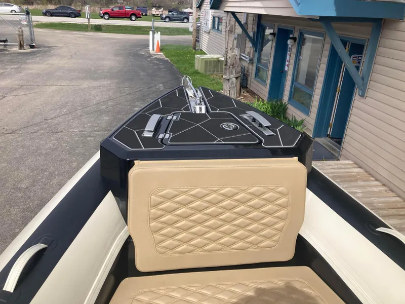 Slide: The Image of Open anchor compartment of 2025 Highfield Sport 700 boat, showcasing chain and winch system. - 7