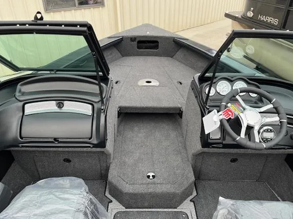 Slide: The Image of 2025 Lund 1875 Crossover XS boat interior with steering wheel and dashboard. - 5