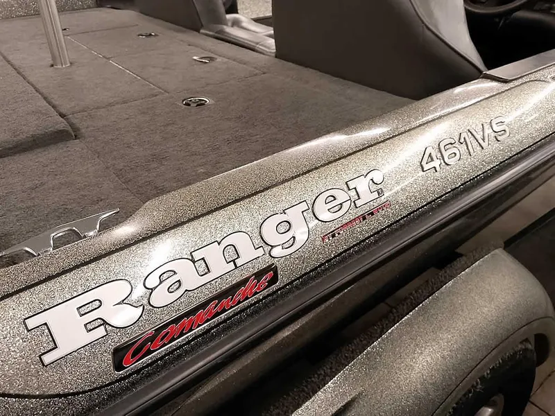 Slide: The Image of 1999 Ranger 461VS Comanche boat, close-up of logo and deck details. - 12