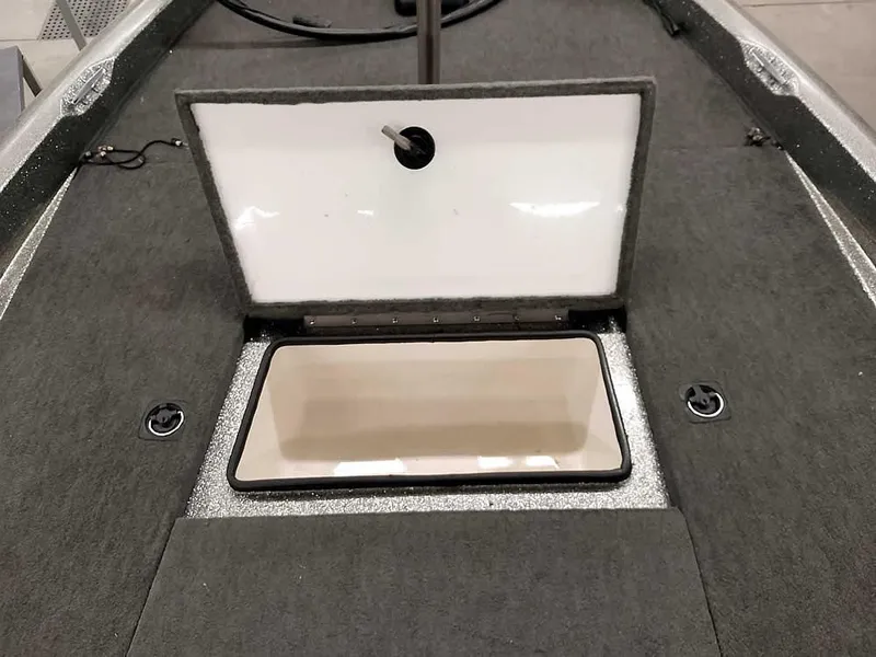 Slide: The Image of 1999 Ranger 461VS Comanche boat storage compartment with open lid, gray carpeted interior. - 15