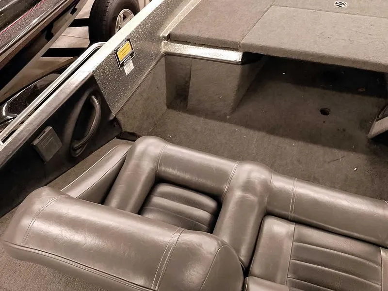 Slide: The Image of 1999 Ranger 461VS Comanche boat interior with gray seating and carpeted deck. - 23