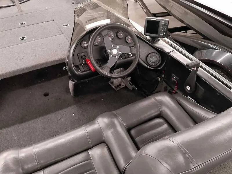 Slide: The Image of 1999 Ranger 461VS Comanche boat interior with steering wheel and dashboard controls. - 25