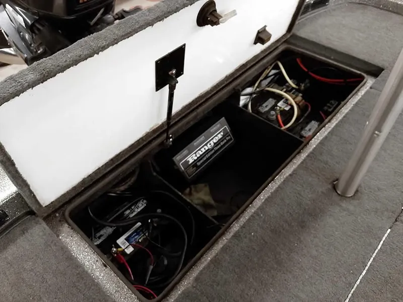Slide: The Image of 1999 Ranger 461VS Comanche boat battery compartment with wiring and storage. - 31