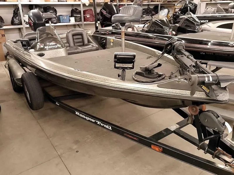 Slide: The Image of 1999 Ranger 461VS Comanche fishing boat on trailer in a garage. - 35