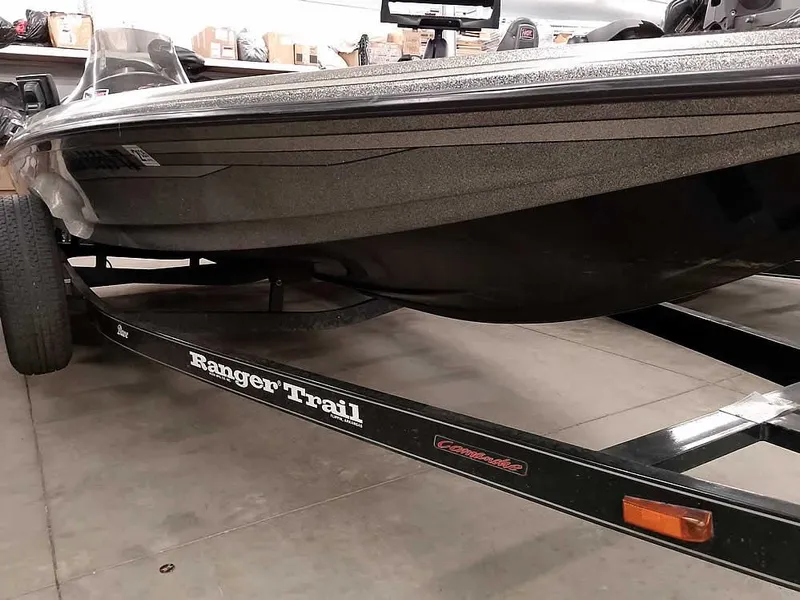 Slide: The Image of 1999 Ranger 461VS Comanche boat on Ranger Trail trailer in a garage. - 4