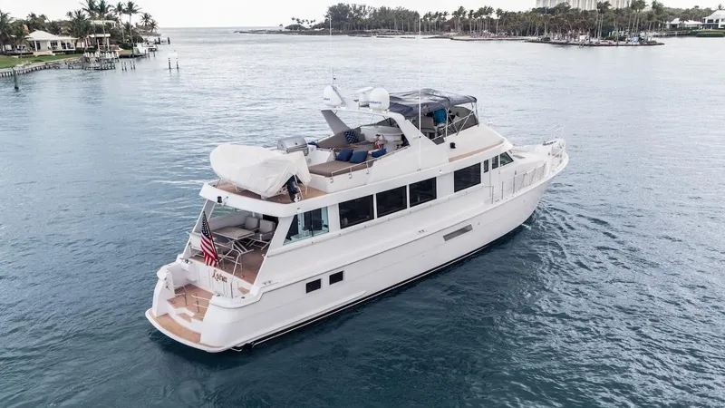 Slide: The Image of 1998 Hatteras 74 Sport Deck Motor Yacht cruising on calm waters. - 15