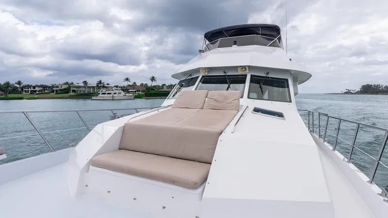 Slide: The Image of 1998 Hatteras 74 Sport Deck Motor Yacht on water, featuring spacious deck and seating. - 18