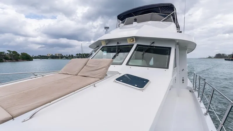 Slide: The Image of 1998 Hatteras 74 Sport Deck Motor Yacht on water under cloudy sky. - 19