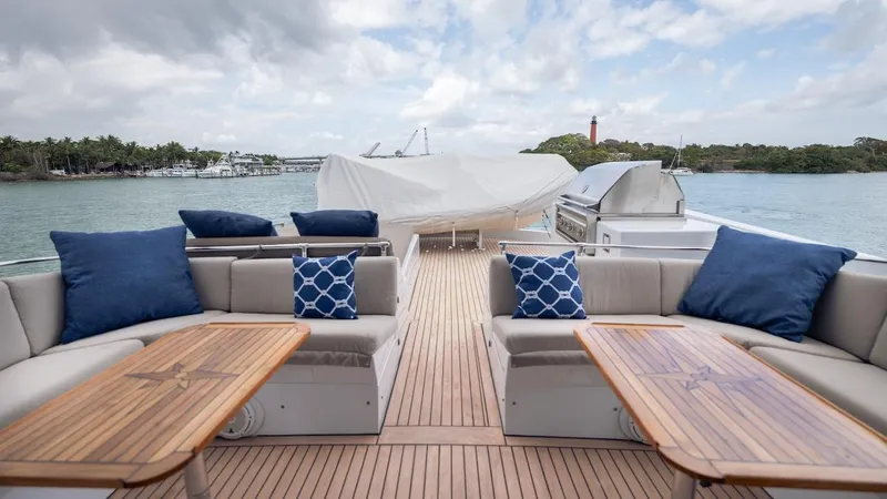 Slide: The Image of Luxurious 1998 Hatteras 74 Sport Deck Motor Yacht with elegant outdoor seating and scenic water views. - 22