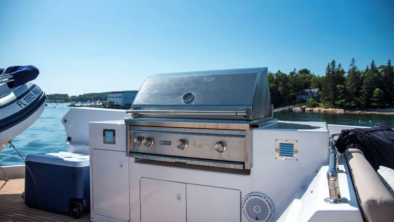 Slide: The Image of Outdoor grill on 1998 Hatteras 74 Sport Deck Motor Yacht, with scenic waterfront view. - 24