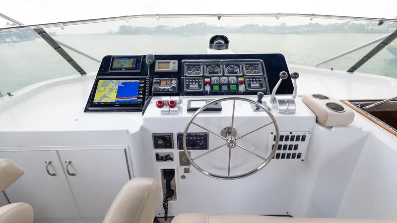 Slide: The Image of Helm of 1998 Hatteras 74 Sport Deck Motor Yacht with navigation instruments and steering wheel. - 27