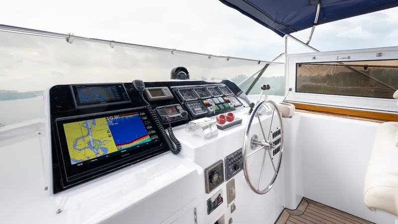 Slide: The Image of Cockpit of 1998 Hatteras 74 Sport Deck Motor Yacht with navigation equipment and steering wheel. - 30