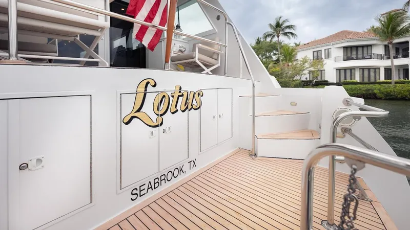 Slide: The Image of 1998 Hatteras 74 Sport Deck Motor Yacht docked, featuring "Lotus" name and Seabrook, TX location. - 32