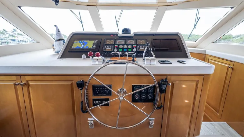 Slide: The Image of Helm of 1998 Hatteras 74 Sport Deck Motor Yacht with navigation controls and steering wheel. - 42