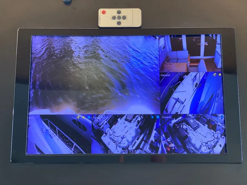 Slide: The Image of Security monitor displaying multiple camera views on a 1998 Hatteras 74 Sport Deck Motor Yacht. - 43