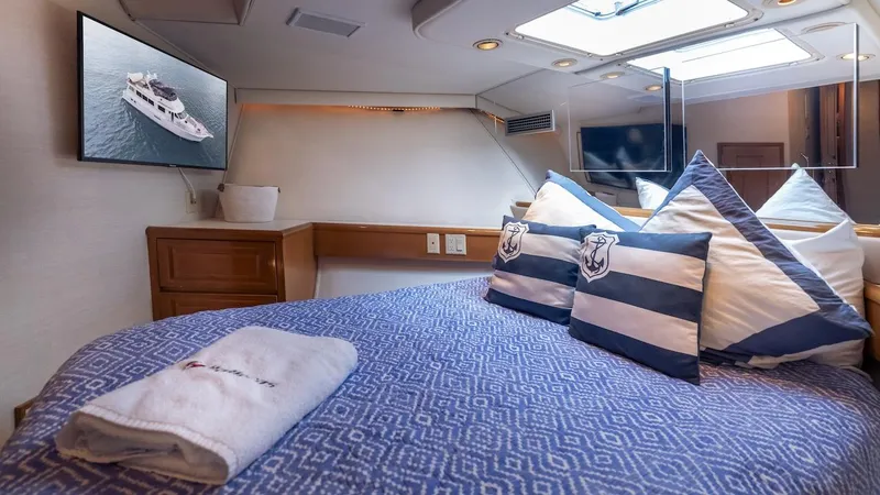 Slide: The Image of Luxurious bedroom interior of 1998 Hatteras 74 Sport Deck Motor Yacht with nautical decor. - 49