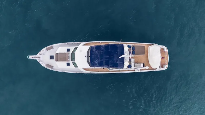 Slide: The Image of Aerial view of 1998 Hatteras 74 Sport Deck Motor Yacht on blue water. - 6