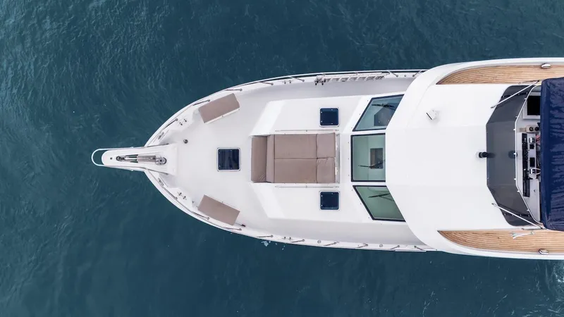 Slide: The Image of Aerial view of 1998 Hatteras 74 Sport Deck Motor Yacht on blue water. - 7