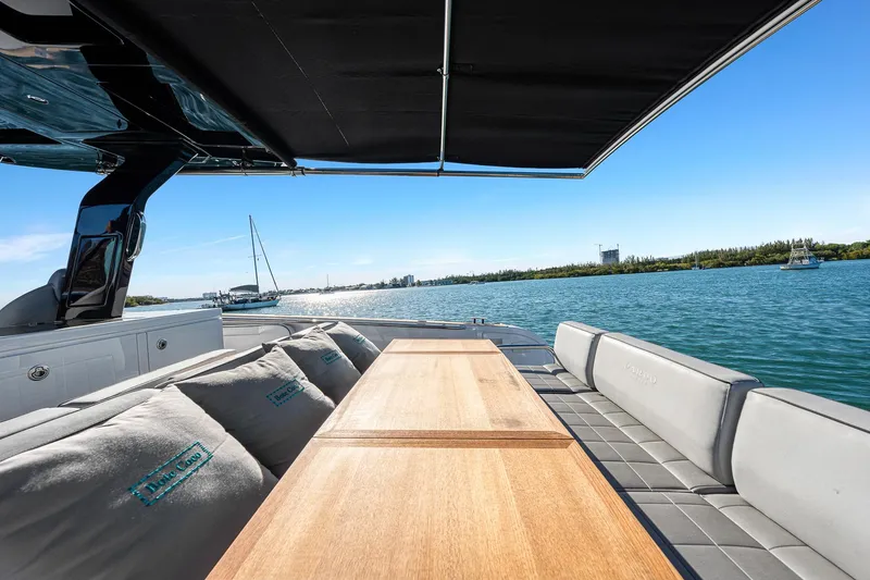 Slide: The Image of 2023 Pardo Yachts P38 deck with seating, table, and scenic water view. - 38