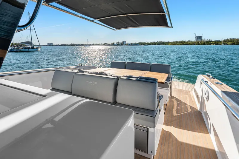 Slide: The Image of 2023 Pardo Yachts P38 luxury deck with seating, overlooking serene waters and clear blue sky. - 41