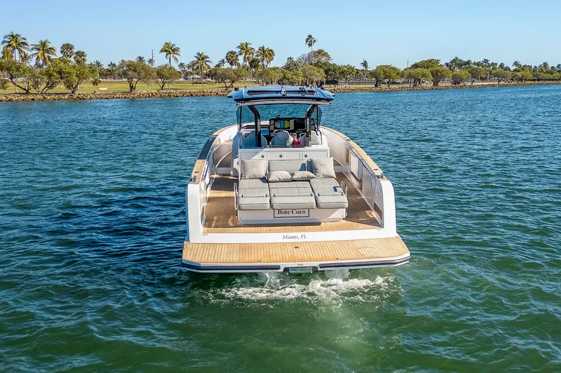 Slide: The Image of 2023 Pardo Yachts P38 cruising on a sunny day with palm trees in the background. - 5