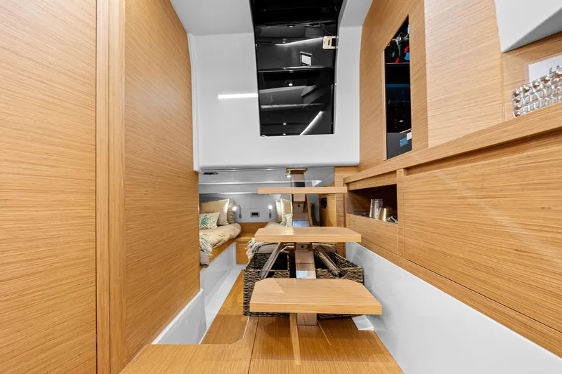 Slide: The Image of Interior of 2023 Pardo Yachts P38, featuring modern wooden design and cozy seating area. - 26