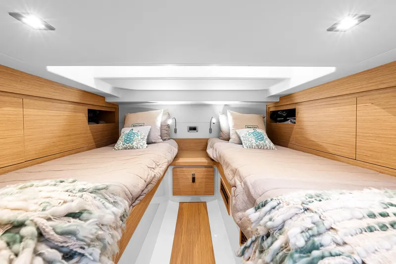 Slide: The Image of Luxurious 2023 Pardo Yachts P38 cabin interior with twin beds and modern wood finish. - 27