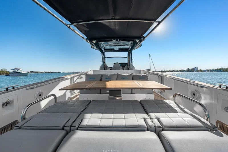 Slide: The Image of 2023 Pardo Yachts P38 luxury deck with seating and table, overlooking serene waters. - 35