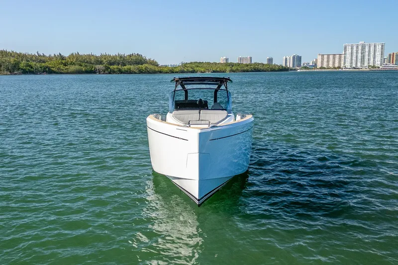Slide: The Image of 2023 Pardo Yachts P38 cruising on calm waters with city skyline in background. - 9