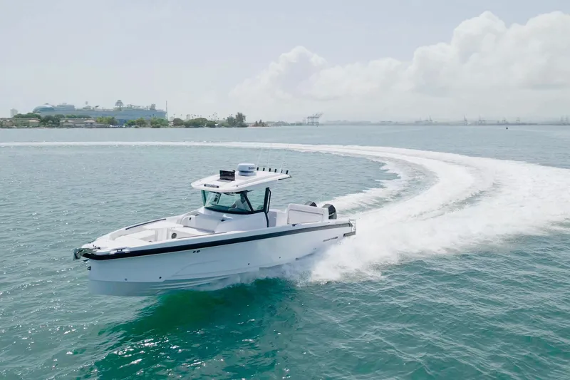 The Image of 2025 Axopar 29 CCX cruising on open water, creating a dynamic wake. - 0