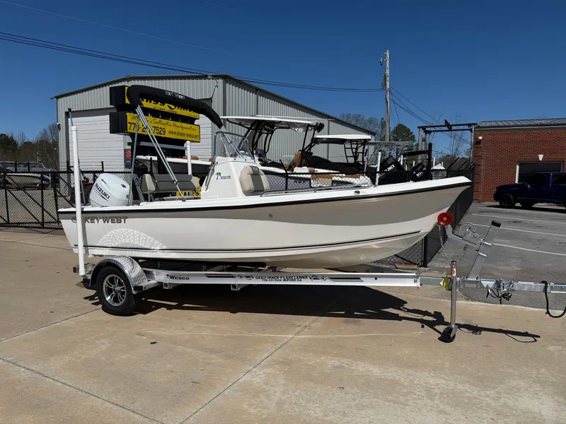 Slide: The Image of 2025 Key West 1720 Center Console boat on trailer, parked outdoors. - 0
