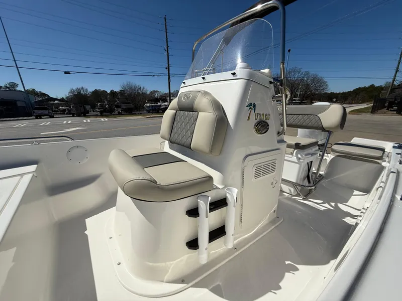 Slide: The Image of 2025 Key West 1720 Center Console boat interior with cushioned seating and steering console. - 11