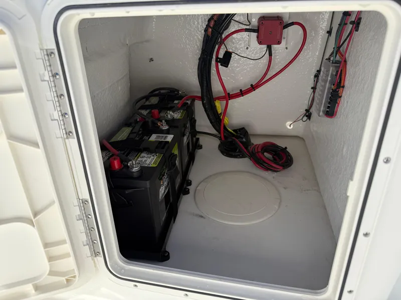 Slide: The Image of Battery compartment of 2025 Key West 1720 Center Console boat, showing wiring and connections. - 13
