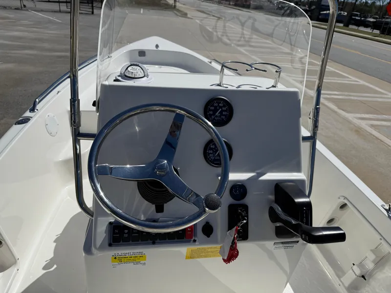 Slide: The Image of 2025 Key West 1720 Center Console boat dashboard with steering wheel and controls. - 16