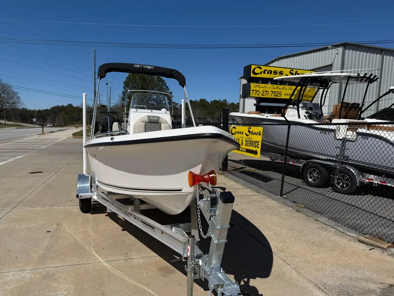 Slide: The Image of 2025 Key West 1720 Center Console boat on trailer, parked outdoors. - 2