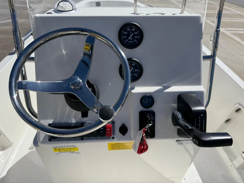 Slide: The Image of 2025 Key West 1720 Center Console boat dashboard with steering wheel and controls. - 24