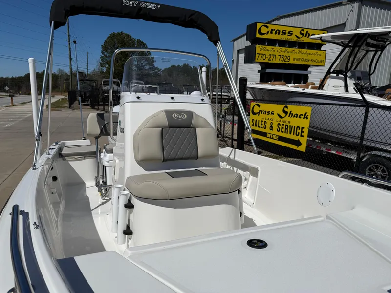 Slide: The Image of 2025 Key West 1720 Center Console boat at dealership, featuring comfortable seating and modern design. - 34