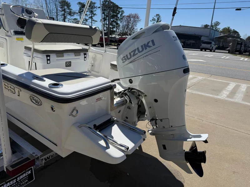 Slide: The Image of 2025 Key West 1720 Center Console boat with Suzuki outboard motor, parked outdoors. - 6