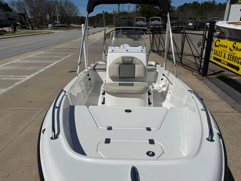 Slide: The Image of 2025 Key West 1720 Center Console boat, white exterior, parked outdoors near sales and service area. - 7