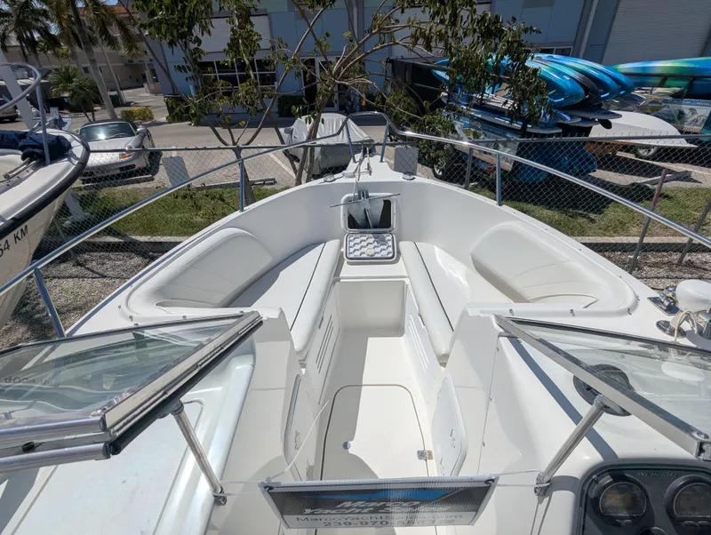Slide: The Image of 2003 Wellcraft 210 Sportsman boat interior with seating and open deck view. - 11