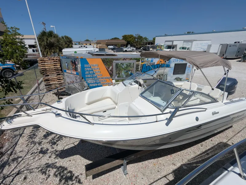 Slide: The Image of 2003 Wellcraft 210 Sportsman boat with canopy in outdoor storage area. - 4