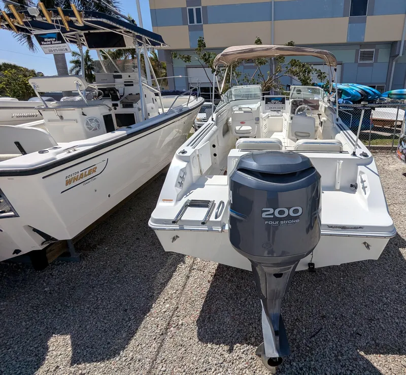 Slide: The Image of 2003 Wellcraft 210 Sportsman boat with 200 horsepower engine, parked outdoors. - 5