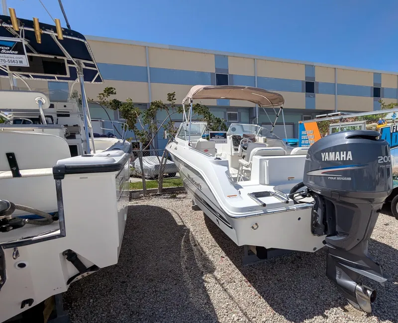 Slide: The Image of 2003 Wellcraft 210 Sportsman boat with Yamaha 200 engine, parked outdoors. - 6