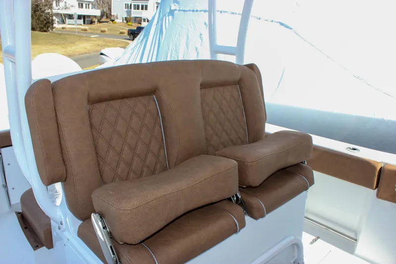 Slide: The Image of 2025 Sea Hunt Gamefish 28 Forward Seating with brown cushioned seats and diamond stitching. - 10