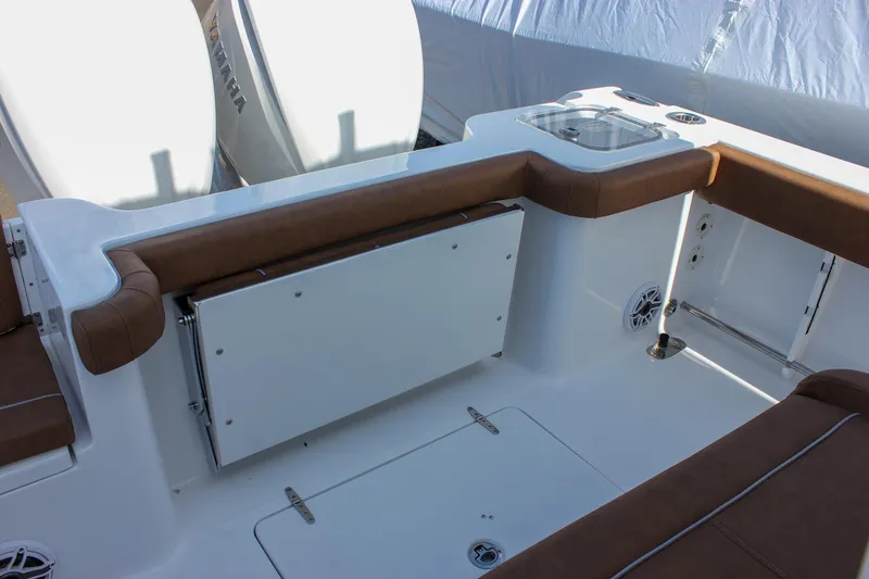 Slide: The Image of 2025 Sea Hunt Gamefish 28 Forward Seating interior with brown cushions and storage compartments. - 19