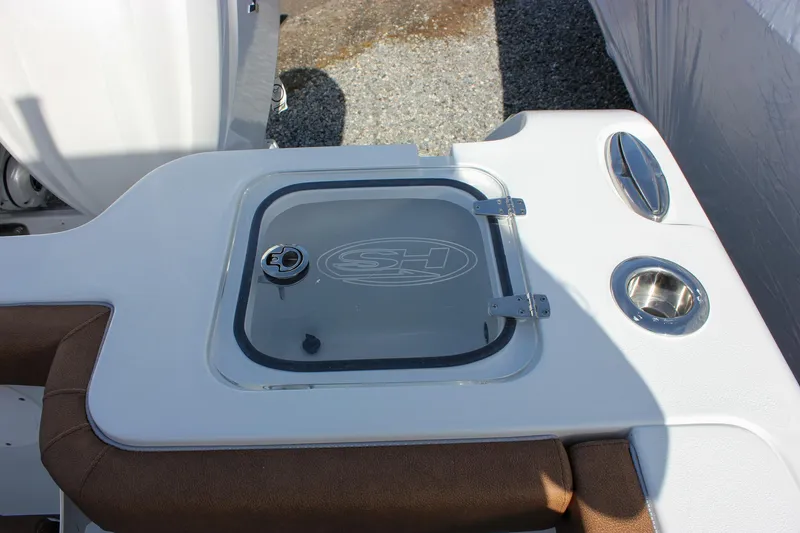 Slide: The Image of 2025 Sea Hunt Gamefish 28 Forward Seating boat detail with storage compartment and cup holder. - 20