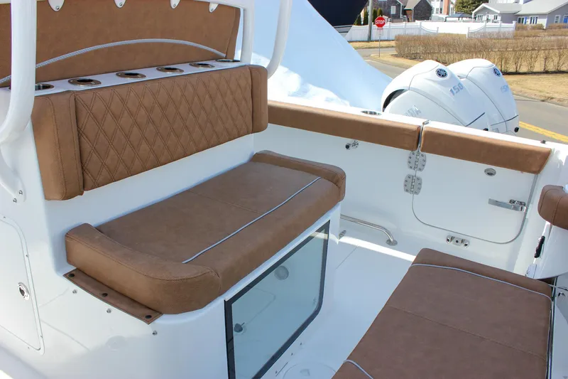 Slide: The Image of 2025 Sea Hunt Gamefish 28 Forward Seating with brown cushioned seats and white exterior. - 22