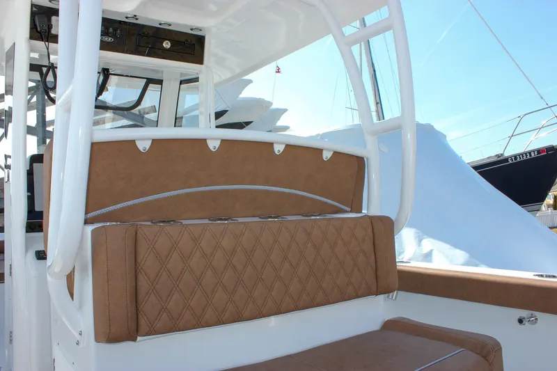 Slide: The Image of 2025 Sea Hunt Gamefish 28 Forward Seating with tan cushioned seats and white frame. - 27